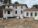 New construction home with red roof and large windows at 515 Penny Ln, Loganville, GA 30052