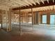 Unfinished interior with exposed framing and large windows at 515 Penny Ln, Loganville, GA 30052
