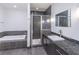 Spa-like bathroom featuring a soaking tub, shower, and double vanity at 222 12Th Ne St # 1701, Atlanta, GA 30309