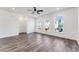 Bright living room with hardwood floors, a ceiling fan, and three large windows at 250 Lytham Se Dr, Mableton, GA 30126