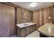 Simple wet bar with wood cabinets and countertop in the basement at 731 Willow Ridge Dr, Marietta, GA 30068