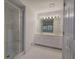 Bright bathroom featuring a double sink vanity, tiled floor and glass shower at 731 Willow Ridge Dr, Marietta, GA 30068