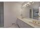 Well-lit bathroom with double sinks, vanity, large mirror and tiled floors at 731 Willow Ridge Dr, Marietta, GA 30068
