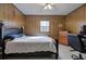 Comfortable bedroom with a full-sized bed, wood-look walls, and natural light from the window at 731 Willow Ridge Dr, Marietta, GA 30068