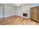Bedroom featuring hardwood floors, a whitewashed fireplace and mantel, and a spacious closet for ample storage at 731 Willow Ridge Dr, Marietta, GA 30068