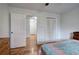 This is a bright bedroom, with a doorway, closet, and hardwood floors at 731 Willow Ridge Dr, Marietta, GA 30068