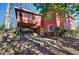 Two-story red house featuring a balcony and patio perfect for enjoying the outdoor living space at 731 Willow Ridge Dr, Marietta, GA 30068