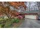 Charming home with a well-maintained driveway, a two-car garage, and lush, mature landscaping at 731 Willow Ridge Dr, Marietta, GA 30068