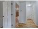 Hallway with white trim, hardwood floors, white doors, and neutral wall paint at 731 Willow Ridge Dr, Marietta, GA 30068