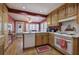 Cozy kitchen featuring wood cabinets, a white oven, and a view into the breakfast nook at 731 Willow Ridge Dr, Marietta, GA 30068