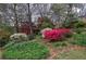 Lush, colorful landscaping featuring azaleas and mature trees surrounding the home at 731 Willow Ridge Dr, Marietta, GA 30068