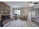 Bright living room with brick fireplace, neutral decor, and light tile floors at 731 Willow Ridge Dr, Marietta, GA 30068