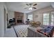 Cozy living room with brick fireplace, ceiling fan, and access to the outdoors through glass panel door at 731 Willow Ridge Dr, Marietta, GA 30068