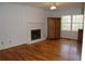 Bright living room with hardwood floors, a painted brick fireplace, and ample natural light at 731 Willow Ridge Dr, Marietta, GA 30068