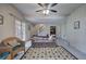 Spacious living room with neutral decor, light tile floors, and stairs leading to the basement at 731 Willow Ridge Dr, Marietta, GA 30068