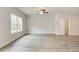 Bright, spacious bedroom features wood-look floors and ample natural light from a large window at 4311 Portsbrook Ave, Snellville, GA 30039