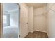 Bedroom leading to walk-in closet with white wire shelving and carpet flooring at 4311 Portsbrook Ave, Snellville, GA 30039