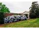 The City of Snellville building with lush hydrangeas landscaping with a brick wall backdrop at 4311 Portsbrook Ave, Snellville, GA 30039