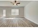 Bright, spacious living room with a view of the backyard through a large window and a glass door at 4311 Portsbrook Ave, Snellville, GA 30039