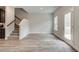 Spacious living area featuring wood flooring, stairs to the upper level, and back door at 4311 Portsbrook Ave, Snellville, GA 30039