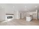 Open-concept living space featuring an electric fireplace and a kitchen island with pendant lighting at 4311 Portsbrook Ave, Snellville, GA 30039