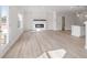 Bright, open-concept living space with wood-look floors, fireplace and access to the kitchen at 4311 Portsbrook Ave, Snellville, GA 30039