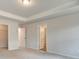Main bedroom with carpet flooring, neutral walls, and tray ceiling at 4311 Portsbrook Ave, Snellville, GA 30039