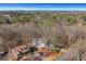 Aerial view of property showing home's setting in wooded area at 4571 Deep Creek Dr, Sugar Hill, GA 30518