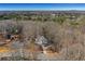 Aerial view showcasing home's wooded setting and driveway at 4571 Deep Creek Dr, Sugar Hill, GA 30518