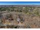 Aerial view of house nestled in trees with long driveway at 4571 Deep Creek Dr, Sugar Hill, GA 30518