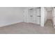 Bright bedroom with grey carpet and built-in shelving at 4571 Deep Creek Dr, Sugar Hill, GA 30518