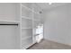 Large walk-in closet with built-in shelving and rods at 4571 Deep Creek Dr, Sugar Hill, GA 30518