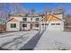 Two-story house with a three-car garage and wood accents at 4571 Deep Creek Dr, Sugar Hill, GA 30518