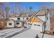 Modern farmhouse with wood accents and three-car garage at 4571 Deep Creek Dr, Sugar Hill, GA 30518