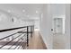 Bright hallway with hardwood floors and modern railing at 4571 Deep Creek Dr, Sugar Hill, GA 30518