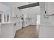 Modern white kitchen with island and hardwood floors at 4571 Deep Creek Dr, Sugar Hill, GA 30518