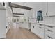 Modern white kitchen with custom cabinetry and quartz countertops at 4571 Deep Creek Dr, Sugar Hill, GA 30518