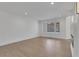 Light-filled living room with hardwood floors and large windows at 4571 Deep Creek Dr, Sugar Hill, GA 30518