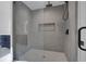 Spacious shower with gray tile and a frameless glass enclosure at 4571 Deep Creek Dr, Sugar Hill, GA 30518