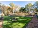 Landscaped backyard with artificial turf, retaining wall, and a bench at 1260 Amanda Cir, Decatur, GA 30033