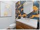 Stylish powder room with cheetah print wallpaper, a wood vanity, and gold fixtures at 1260 Amanda Cir, Decatur, GA 30033