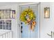 Light blue front door with a magnolia wreath at 1260 Amanda Cir, Decatur, GA 30033