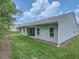 Backyard view featuring green grass and the exterior of the home at 213 Cottontail Ln, Villa Rica, GA 30180