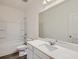 Bright bathroom featuring a shower-tub combination and a large mirror over the white vanity at 213 Cottontail Ln, Villa Rica, GA 30180