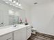 Well-lit bathroom with a long vanity, white cabinetry, and a shower-tub combination at 213 Cottontail Ln, Villa Rica, GA 30180