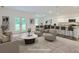 Bright and airy staged living room with modern finishes adjacent to dining and kitchen area at 213 Cottontail Ln, Villa Rica, GA 30180