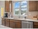 Modern kitchen sink with stainless steel dishwasher and cabinetry at 237 Lytham Se Dr, Mableton, GA 30126