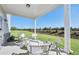 Relaxing covered patio with seating area and view of grassy backyard at 3136 Morris Hills Dr, Dacula, GA 30019