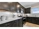 Modern kitchen with dark cabinetry, white subway tile backsplash and stainless steel appliances at 3136 Morris Hills Dr, Dacula, GA 30019