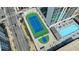 An aerial view shows a tennis court, basketball court, and swimming pool next to a high rise at 1280 W Peachtree Nw St # 3009, Atlanta, GA 30309